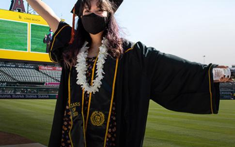 Graduate standing on field at  Anaheim Stadium