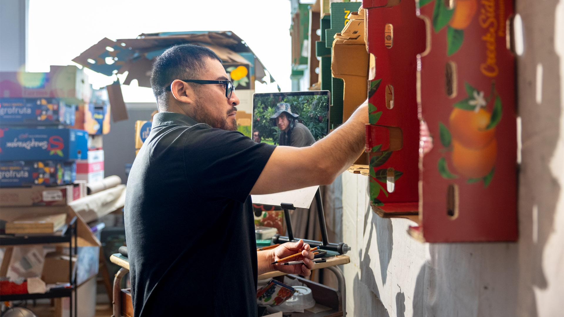 Narsiso Martinez paints in his studio