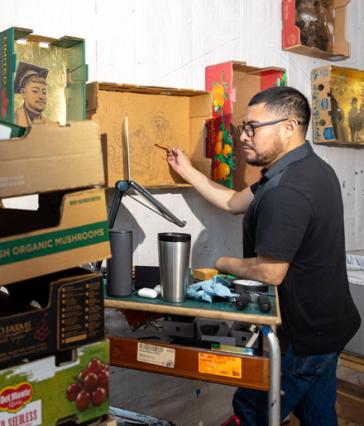 Narsiso Martinez paints in his studio