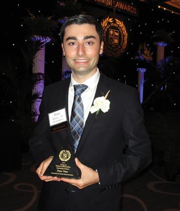 CSULB alumnus Peter Velez '16 holding an award