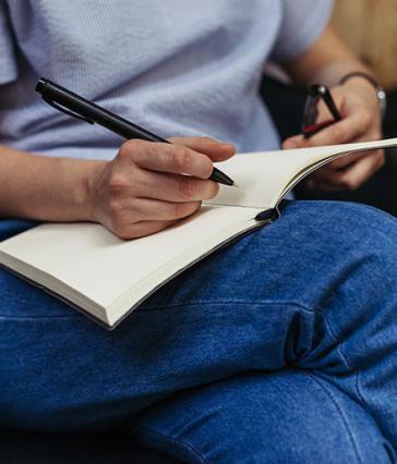 Woman therapist writing down notes