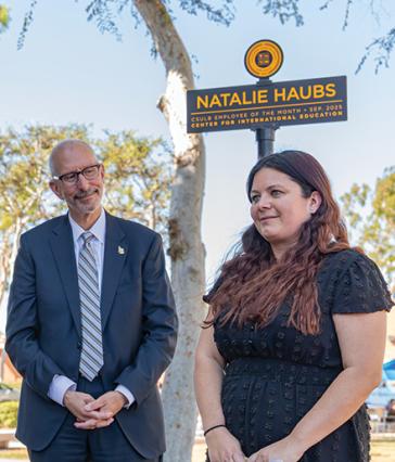 President Andrew Jones stands with Employee of the Month Natalie Haubs