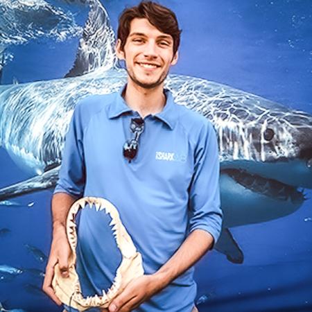 Shark Lab Field Technician and grad student Zach Merson with the jawbone of a shark