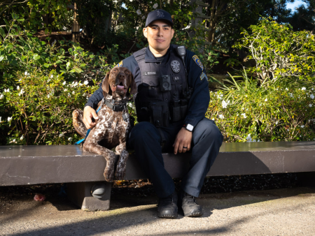 Corporal Rocha and K9 Porto Sitting on a Bench