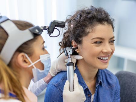 audiologist examing patient's ear canal