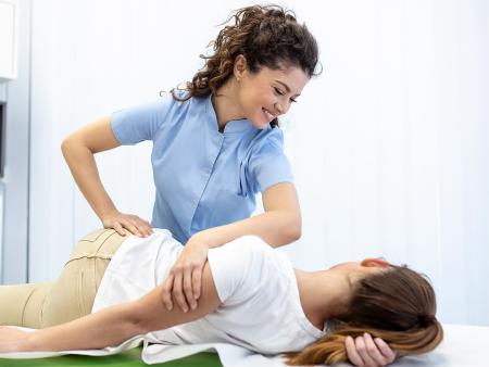 chiropractor adjusting a patient's body