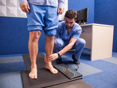 podiatrist examining patient's stance