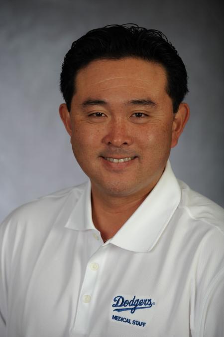 A portrait of Yosuke Nakajima '05 in a white polo shirt with the Dodgers logo in blue