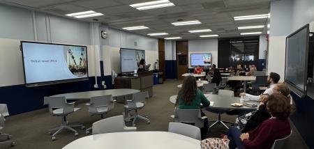 classroom with screens and people at tables