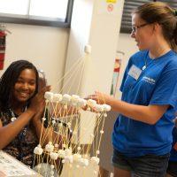 interns doing building marshmallow structure  