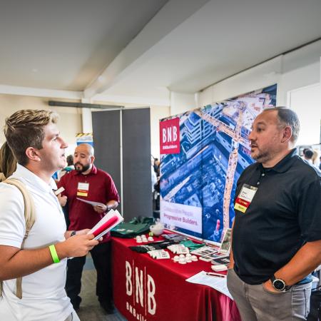 A student and representative of BNB speak at a reverse job fair organized by CSULB.