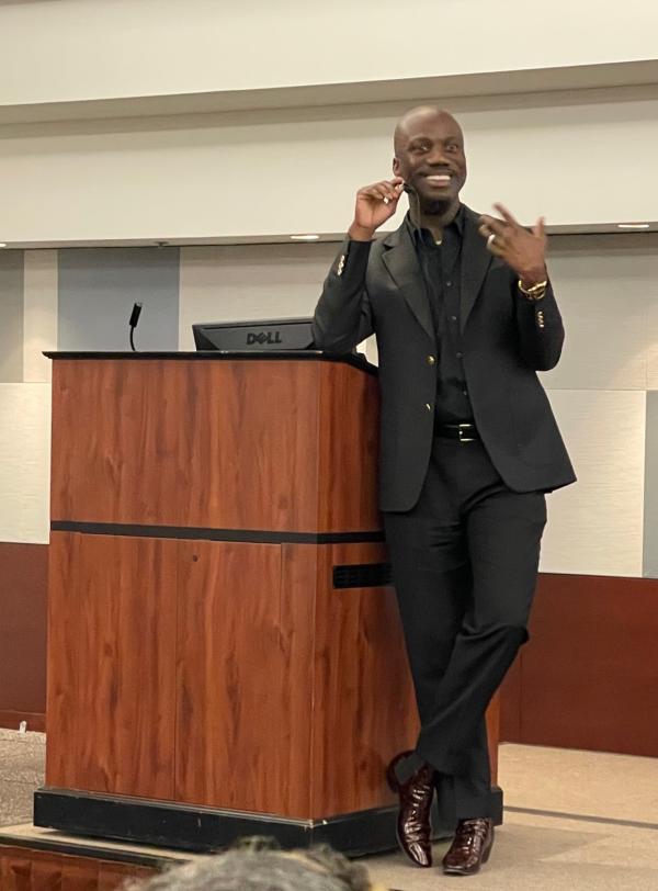 Shaun Harper stands at a podium giving his talk.