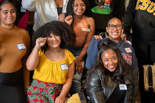 Group of Black people posing together and smiling.