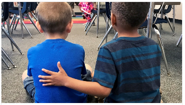 Two boys sit in a classroom