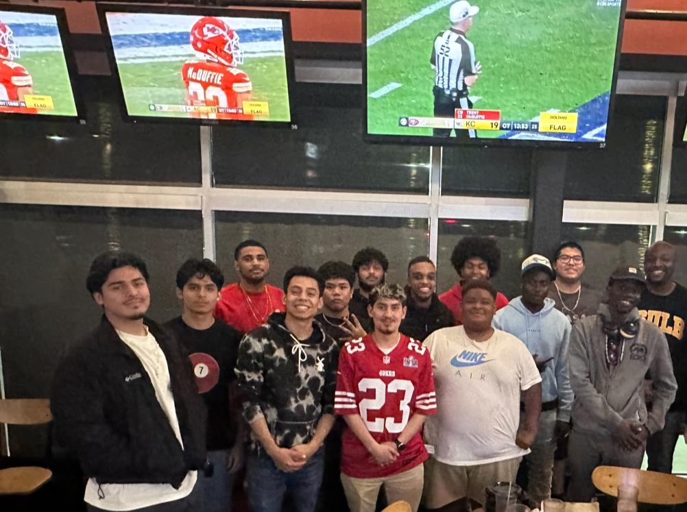 Group of MSI students watching a football game.