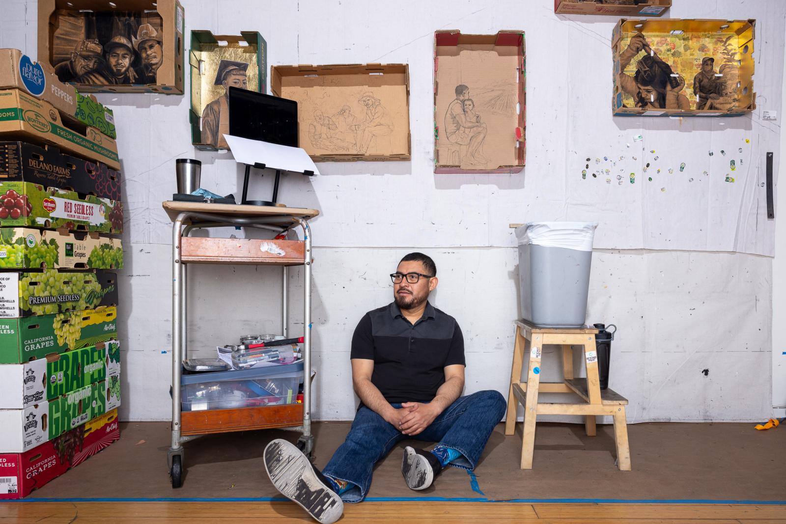 Artist Narsiso Martinez sits in his studio