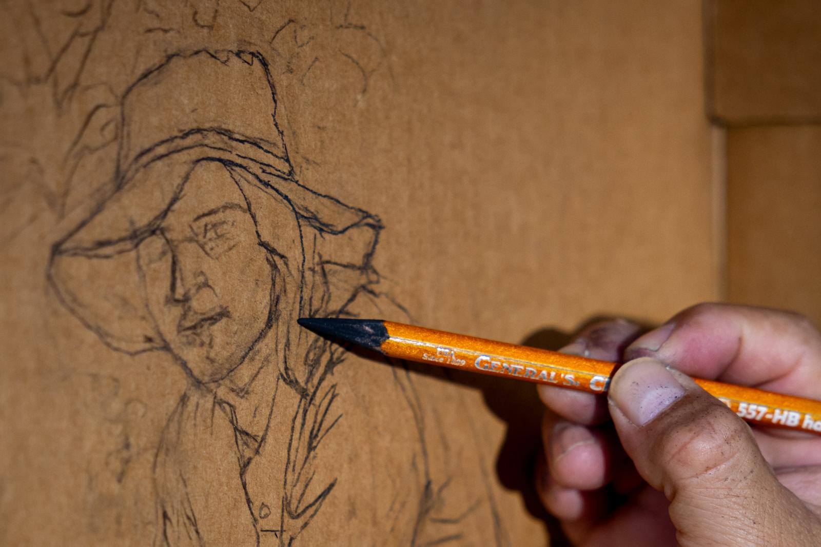 Narsiso Martinez draws a detail of a field worker