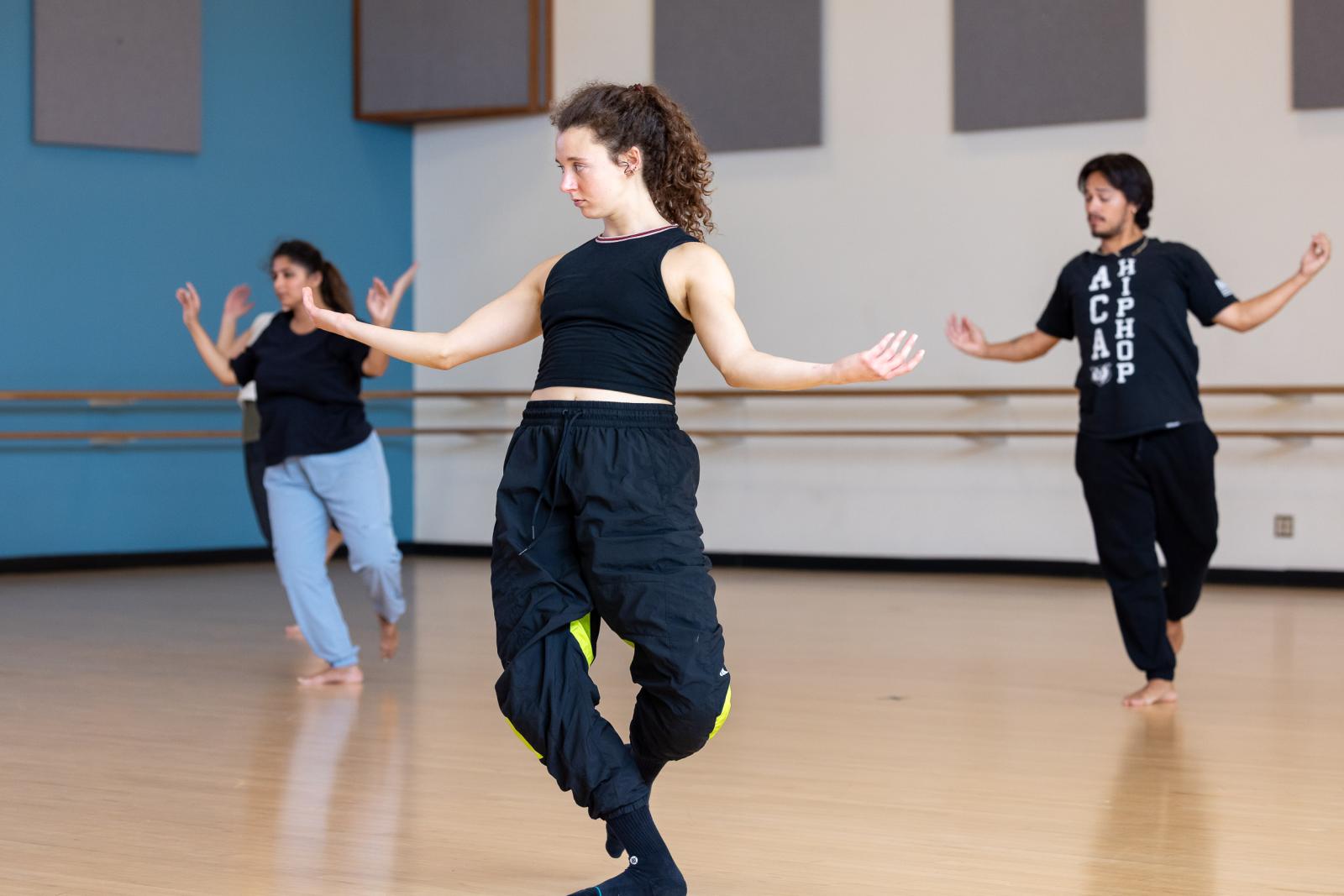 Maggie Ogle, center, learns repertoire during a workshop with A.I.M dancers